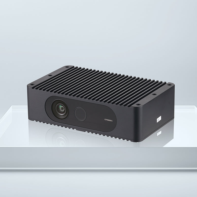 Angled promotional view of industrial Orbbec Femto Mega I 3D camera featuring an IP65 water and dustproof rugged housing.