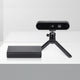 Front view of Orbbec Gemini 2 XL 3D camera on a mini tripod placed alongside the sleek black OBox PoE adapter.